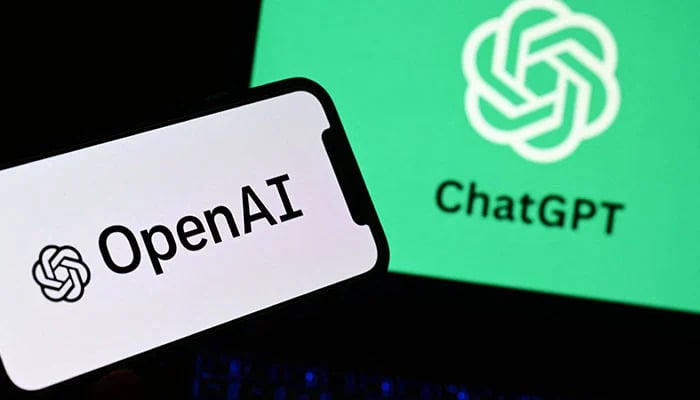 A photo taken on October 4, 2023, in Manta, near Turin, shows a smartphone and a laptop displaying the logos of the artificial intelligence OpenAI research laboratory and ChatGPT robot. — AFP