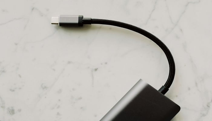 The image shows USB-C cable on white surface. — Pexels
