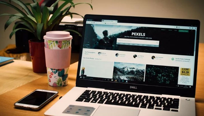 An undated image of  a Grey Dell laptop displaying Pexels webpage.—Canva