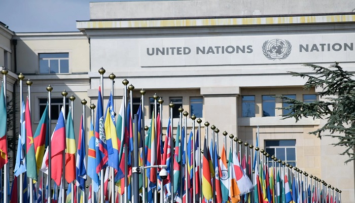 The image shows flags of countries in front of the United Nations office in Geneva. — Pexels