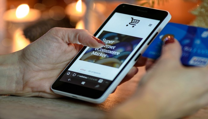 An undated image shows a person shopping online. — Pexels