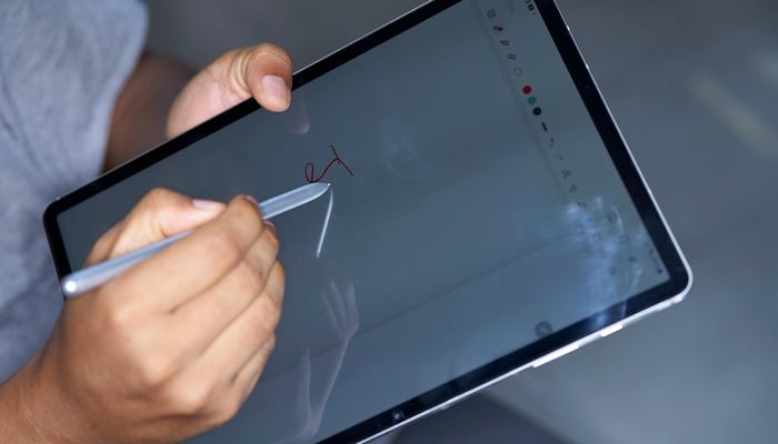 An undated image displaying a man using Apple Pencil on an iPad. — Unsplash