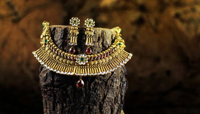 An undated image of gold jewellery displayed at a log. — Freepik