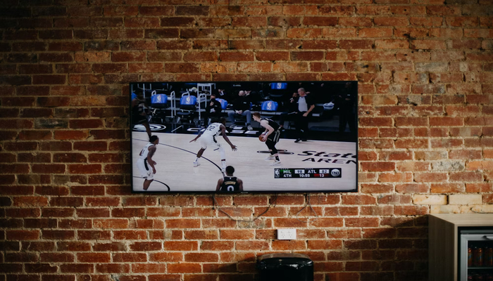 An undated image displays a TV set on a wall. — Unsplash