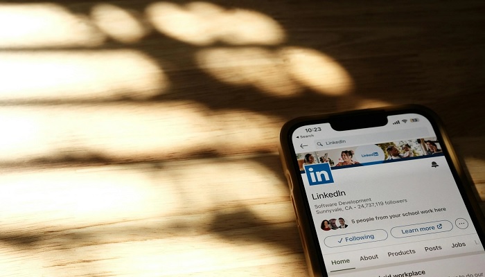 The image shows the LinkedIn app open on a phone. — Pexels