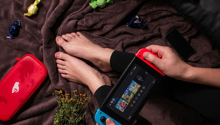 The image shows a person using a Nintendo Switch. — Pexels