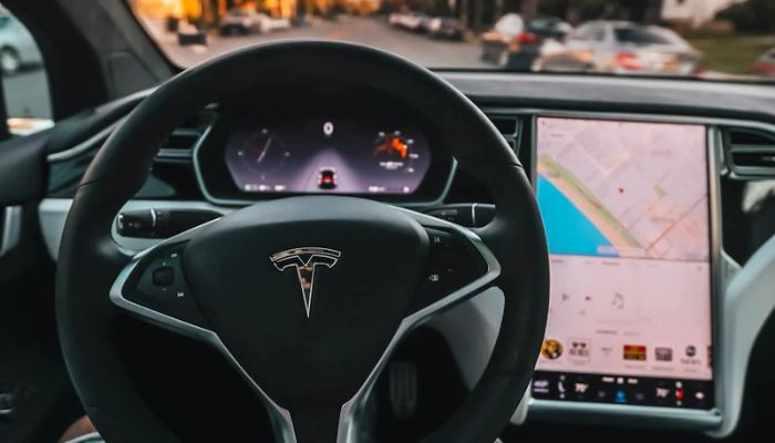 The image shows person inside a Tesla in Santa Monica, CA, United State. — Pexels