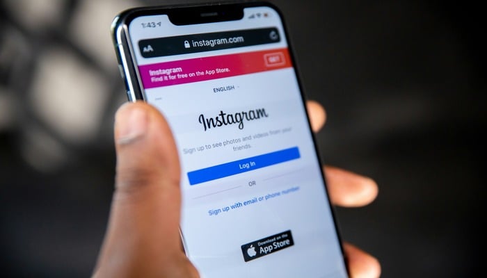An undated image of Instagram login page displayed on a phone. — Unsplash