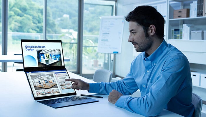An undated image showing a man using new Zenbook Duo (2024). — Asus