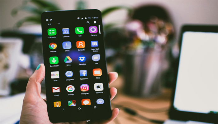 An undated image of a person holding a smartphone. — Pexels