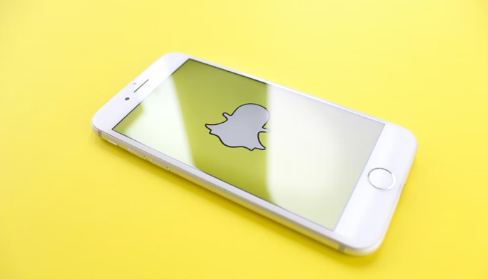 An undated image showing Snapchat logo on mobile screen. — Unsplash