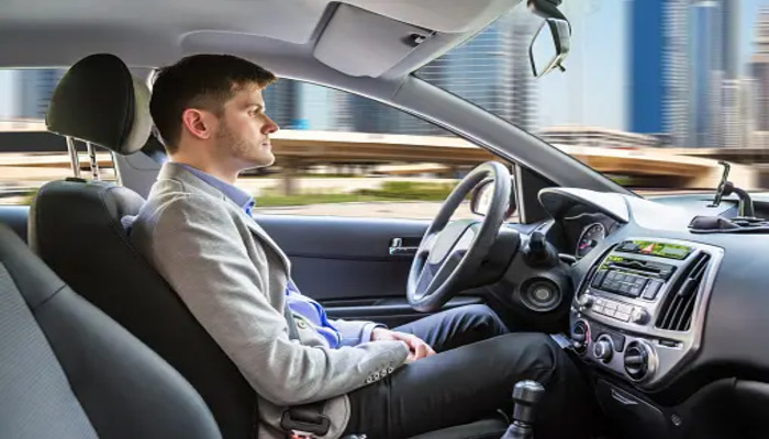 An undated image of a person sitting in a self-driving car. — Unsplash