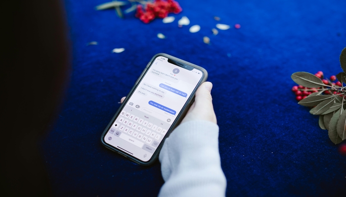 An undated image shows a person reading text messages. — Pexels