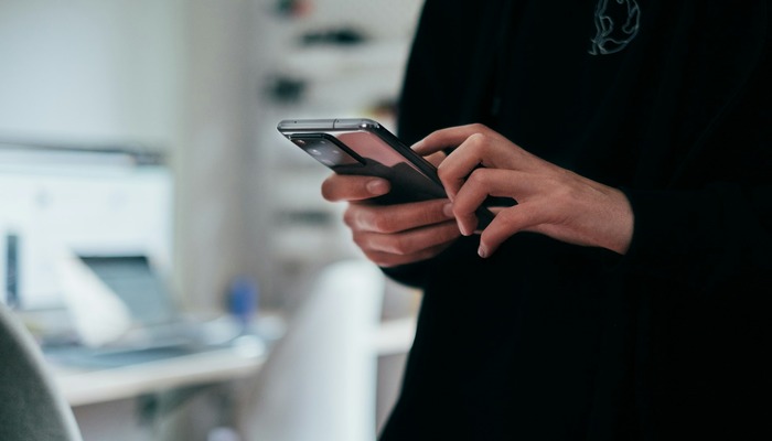 An undated image of a person using an Android phone. — Unsplash
