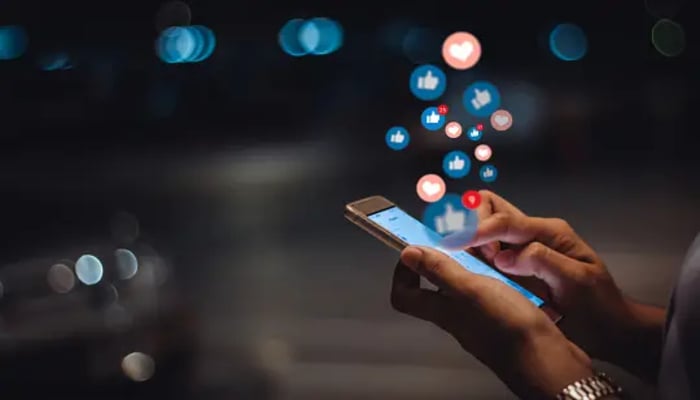 An undated image of a person using social media. — Unsplash