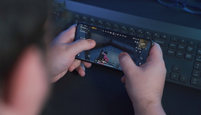An undated image of a person playing a game on a phone. — Unsplash