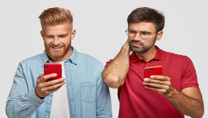 An undated image of two person using phones. — Freepik