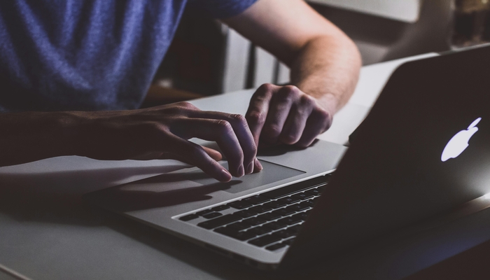 An undated image of a person using a Mac. — Pexels