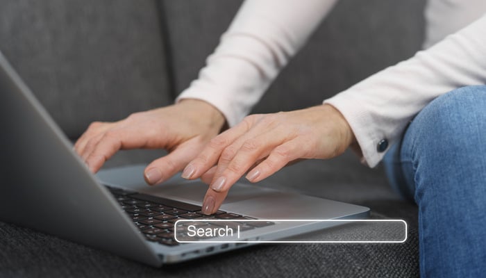 An undated image of a person using laptop. — Freepik