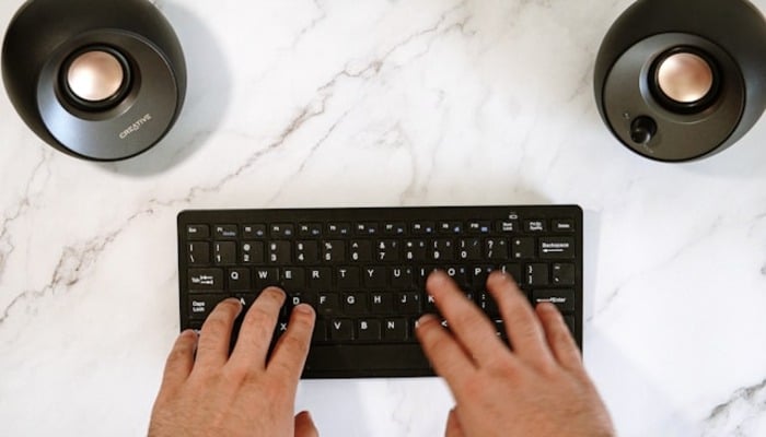 An undated image of a person using a wireless keyboard. — Unsplash