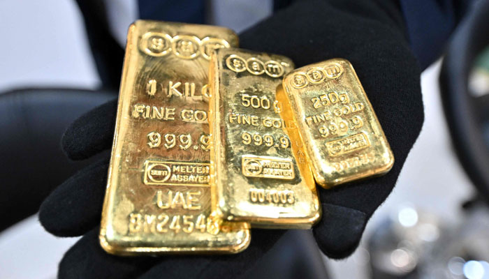 A participant shows gold bars during the 21st edition of the international gold and jewellery exhibition at the Kuwait International Fairgrounds in Kuwait City on May 23, 2024. — AFP