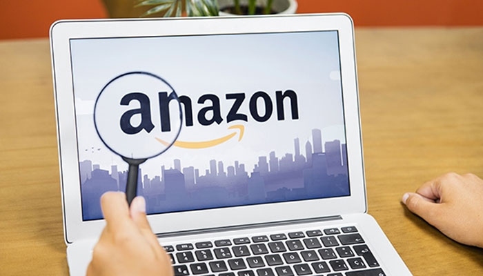 An udnated image of Amazon websites homepage opened on a laptop screen. — Freepik