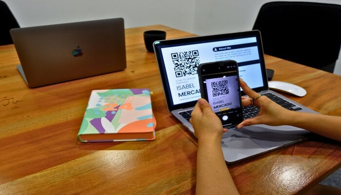 An undated image of a person scanning a QR code. — Unplash