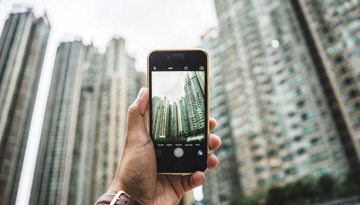 An undated image of a person capturing a photo with a smartphone. — Unsplash