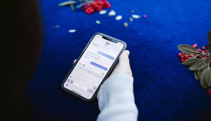 An undated image of a person using messaging app. — Pexels