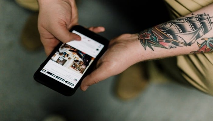 An undated image of a person using a phone. — Unsplash