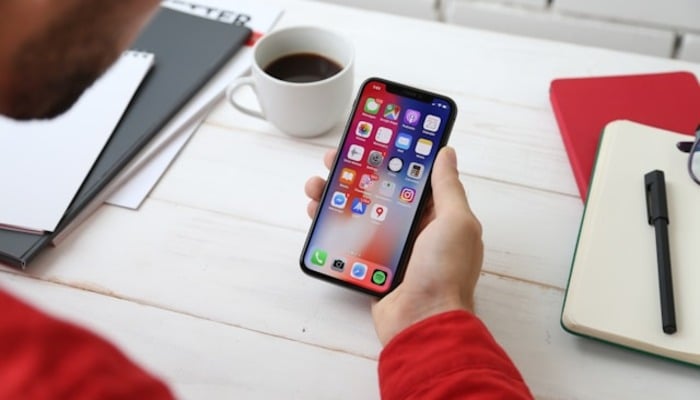 An undated image of a person using an iPhone. — Unsplash