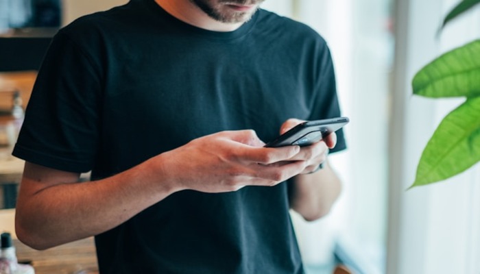 An undated image of a person using a phone. — Unsplash