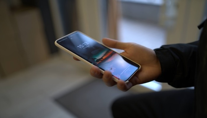 An undated image of a person using a Samsung phone. — Unsplash