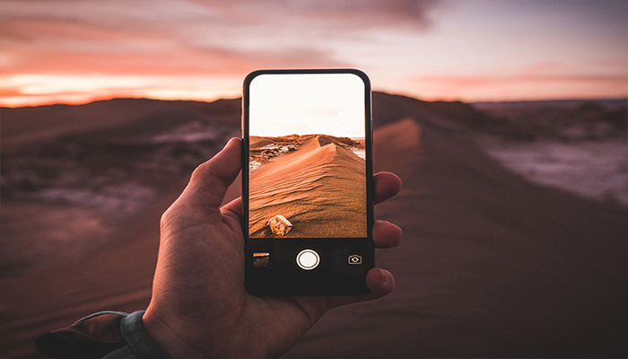 An undated image of a person capturing photo. — Adobe