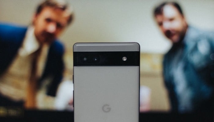 An undated image of two persons looking at Google Pixel phone. — Unsplash