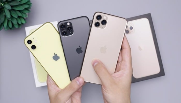 An undated image of a person holding iPhones. — Unsplash