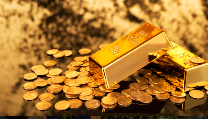 An undated image of gold bars and coins placed on a table. — Reuters