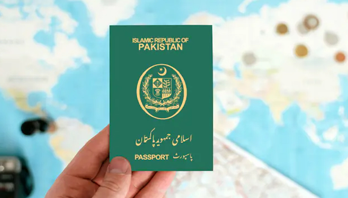 An undated image of a person holding a Pakistani passport. — Shutter Stock
