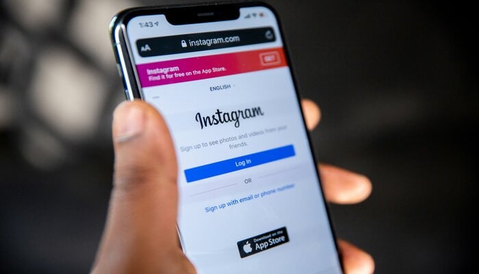 An undated image of a person using Instagram on a smartphone. — Unsplash