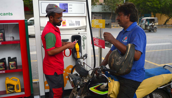 Fuel station worker filling petrol in vehicle at a fuel station in Karachi on Monday, July 1, 2024. — PPI