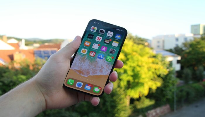 An undated image of a person holding an iPhone. — Unsplash