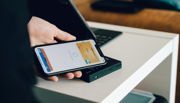 An undated image of a person using Apple Wallet app. — Unsplash