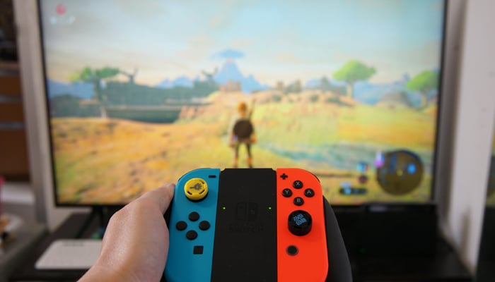 An undated image showing a person playing Nintendo Switch games. — Unsplash