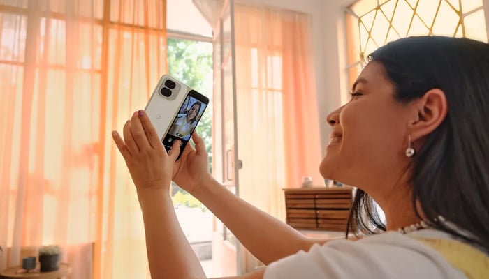 An undated image of a girl using Pixel phone. — Google Blog