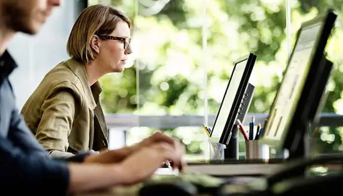 An undated image of two people using their PCs. — Unsplash