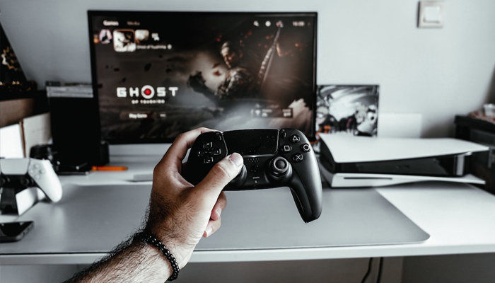 An undated image showing a person playing game on PS5. — Unsplash