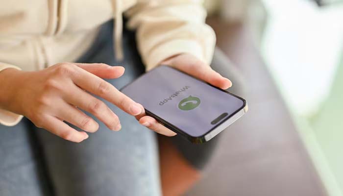 An undated image of a person using WhatsApp. — Freepik