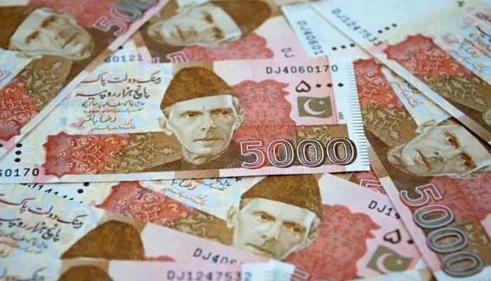 An undated image of several currency notes of PKR 5,000. — Unsplash