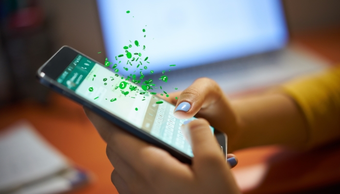 An undated image of a person using WhatsApp. — Canva