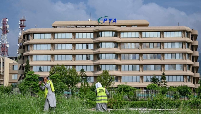 People work near the Pakistan Telecommunication Authority (PTA) headquarters building in Islamabad on August 16, 2024. — AFP